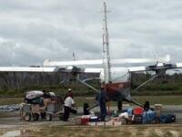 A Twin-Otter being loaded on Bario's new all-weather runway. (93Kb)